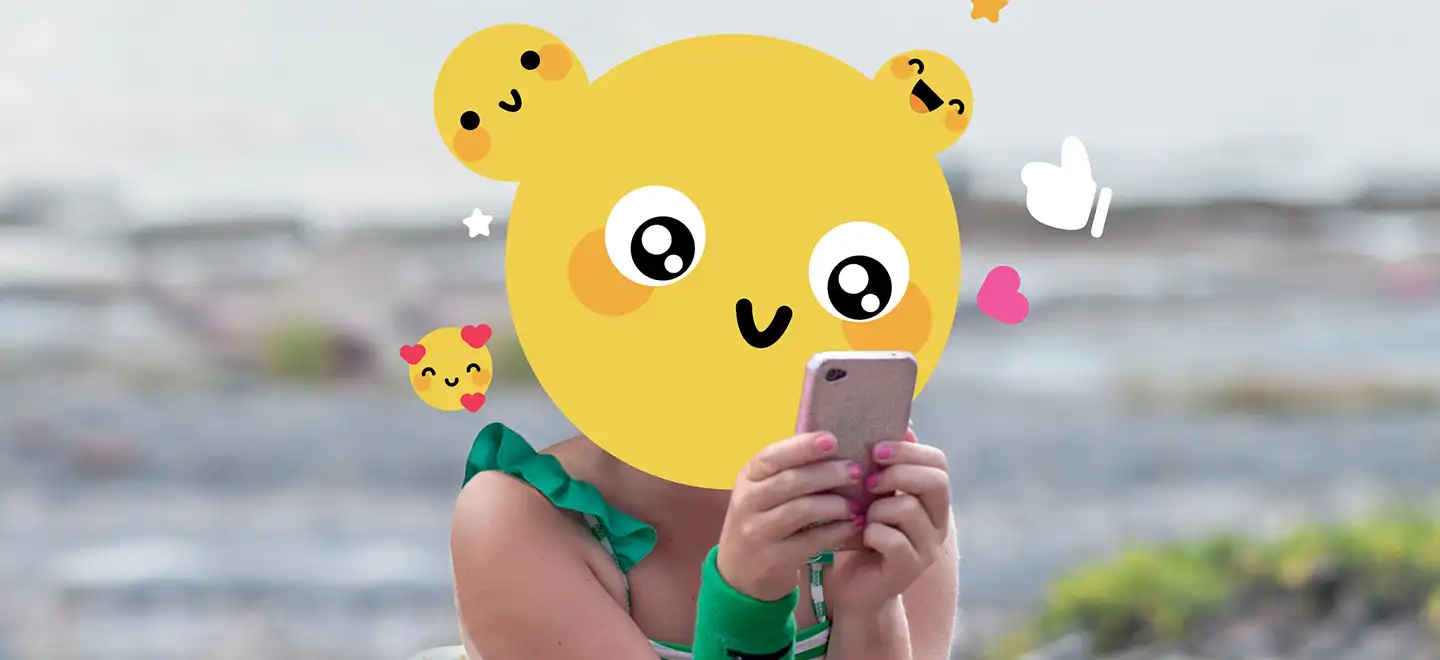 Mädchen am Handy mit Emoji-Kopf