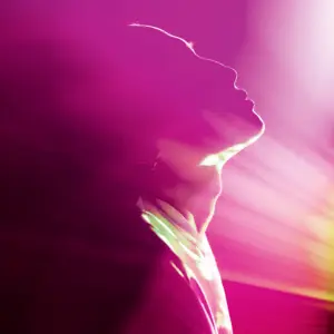 Bild eines Menschen, der nach oben schaut, mit lila Beleuchtung